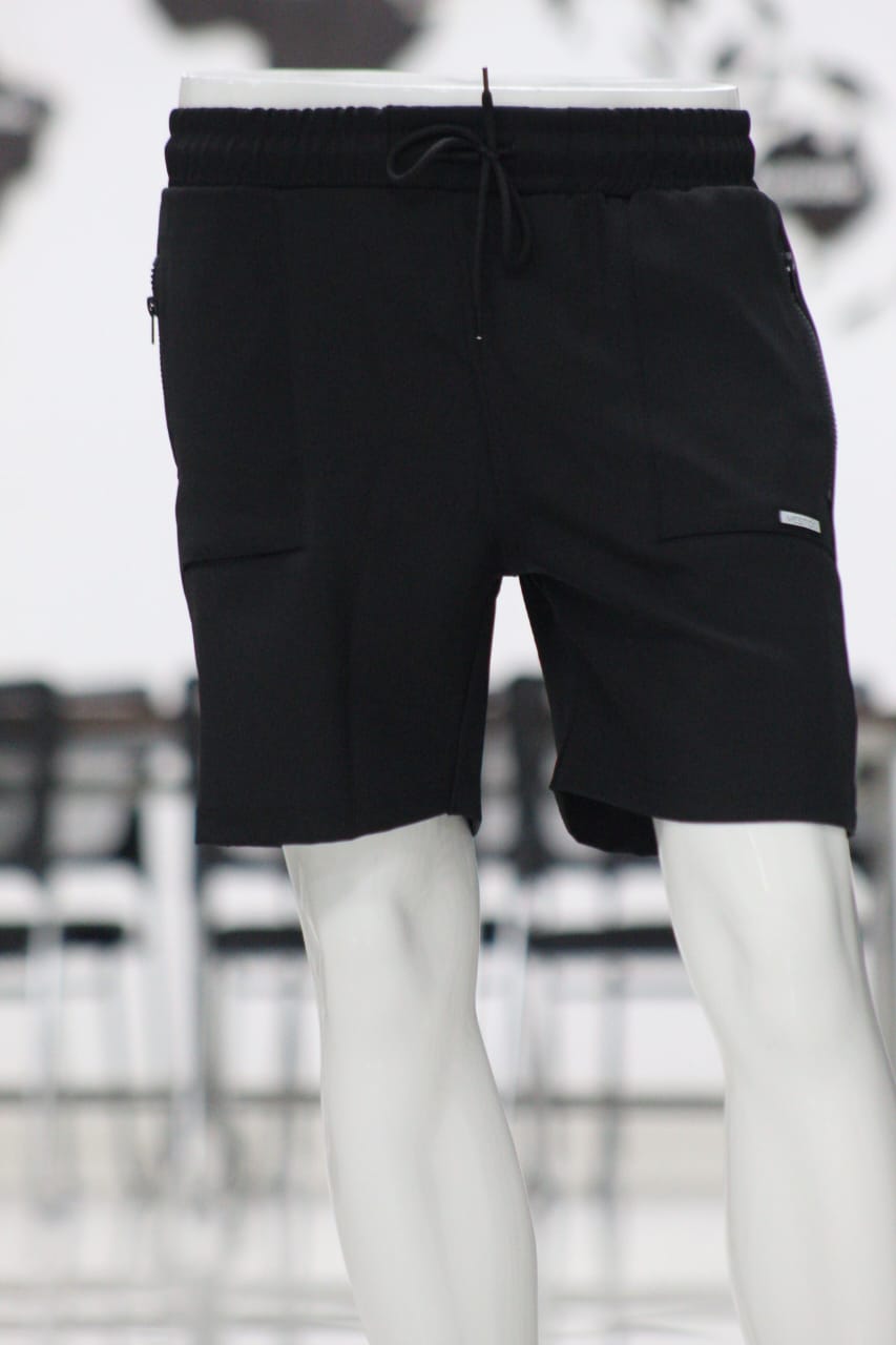 Black shorts on a mannequin with a blurred outdoor background