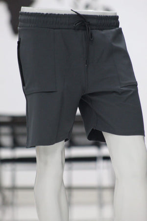Dark gray shorts on a mannequin with a blurred background