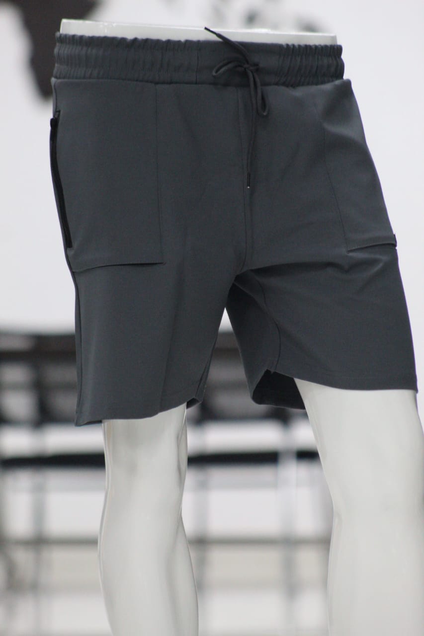 Dark gray shorts on a mannequin with a blurred background
